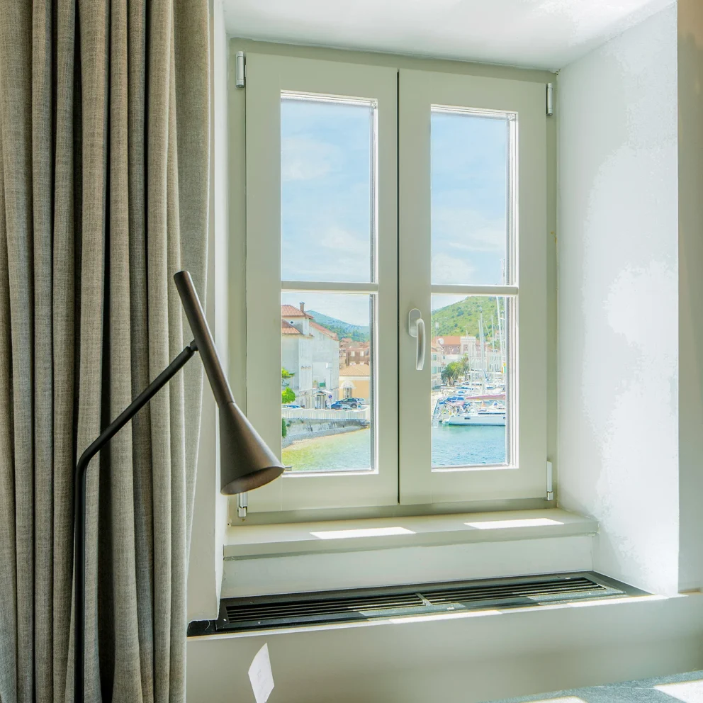 Double room interior with window view of Vis bay at Marshal Club Hotel