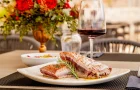 Grilled tuna steak with Mediterranean sides at Marshal Club Hotel restaurant