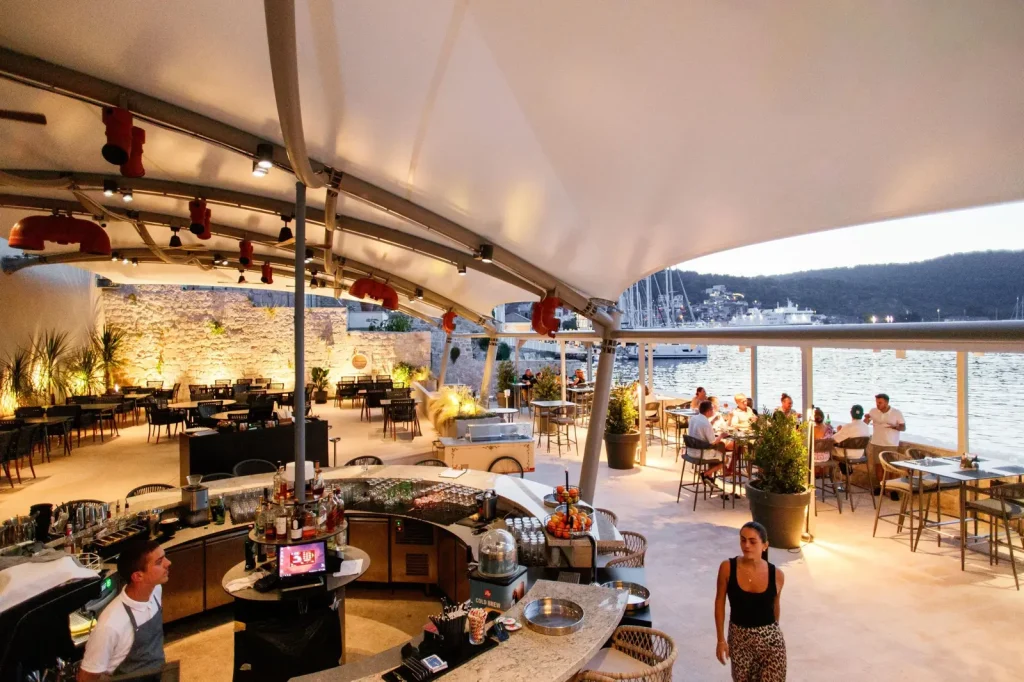 Spacious restaurant terrace at Marshal Club Hotel overlooking Vis harbor